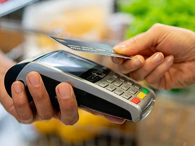 Student purchases groceries with a card.