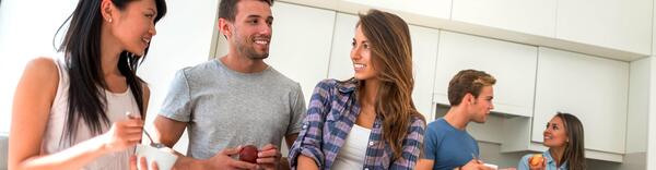 Students socializing in shared kitchen.